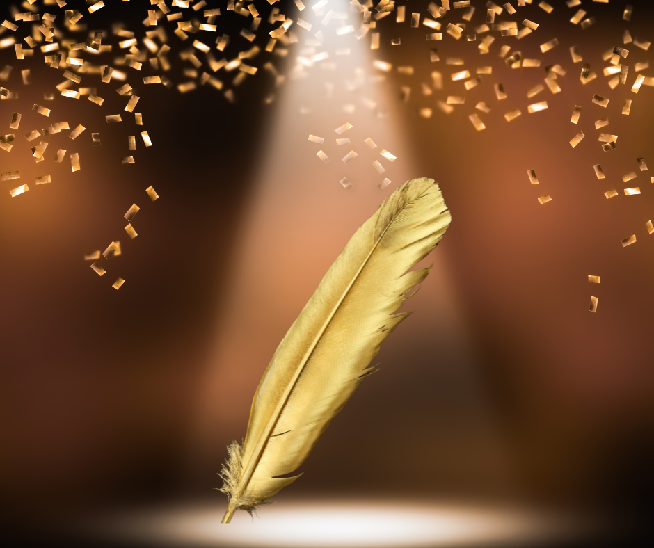 Image of a gold coloured quill under a spitlight with golden confetti